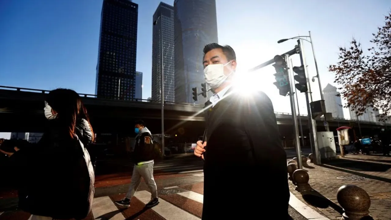  People walk in Chaoyang District, Beijing, China  Photograph:(Reuters) 