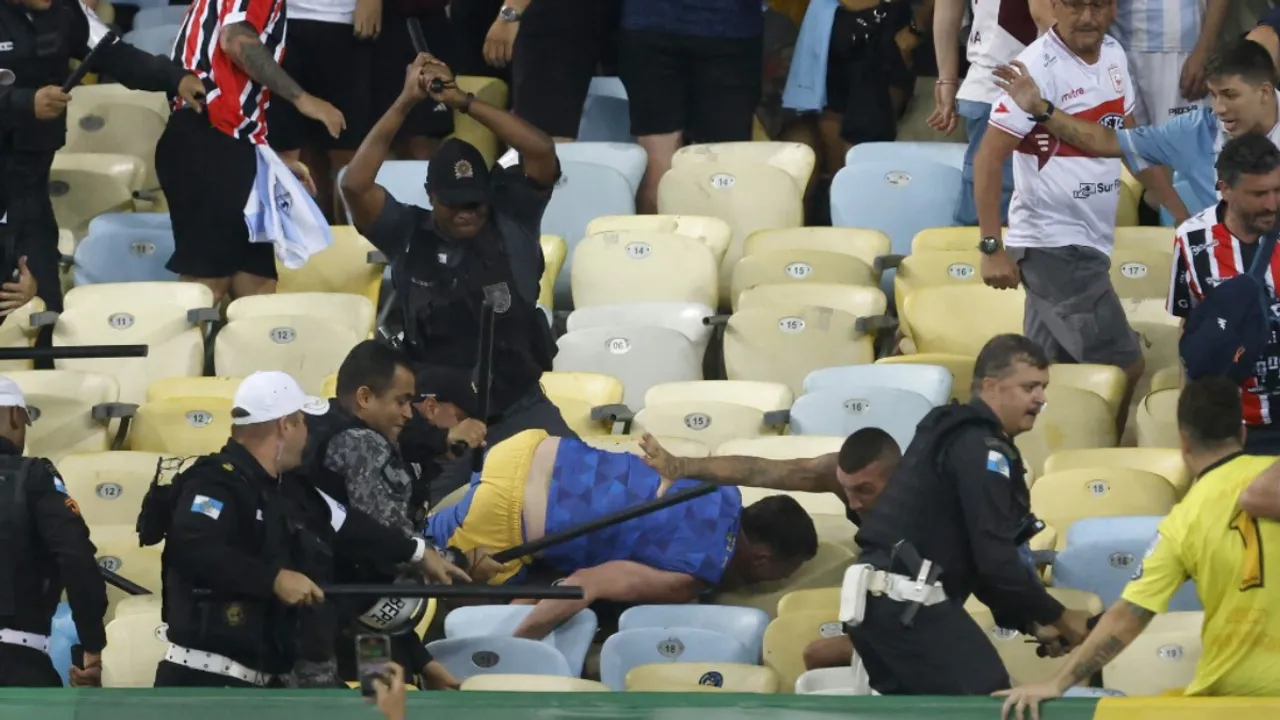  Brazil police beating fans during Argentina vs Brazil WC qualifier match. Photograph:(AFP) 