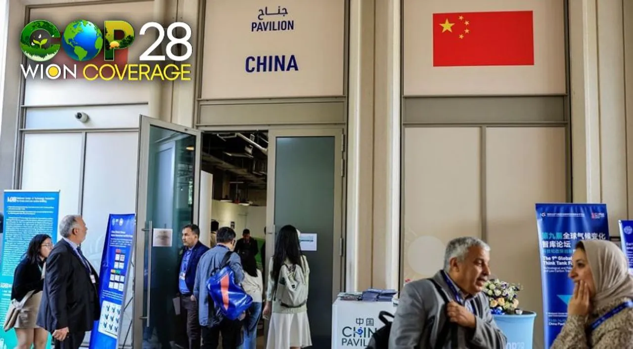  People stand outside the China Pavilion at the United Nations Climate Change Conference COP28 in Dubai, United Arab Emirates, December 6, 2023. Photograph:(Reuters) 