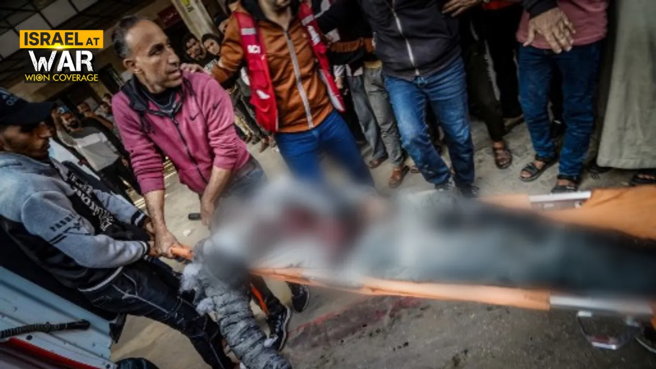  People carry the body of a man killed during Israeli bombardment at Nasser Hospital Photograph:(AFP) 