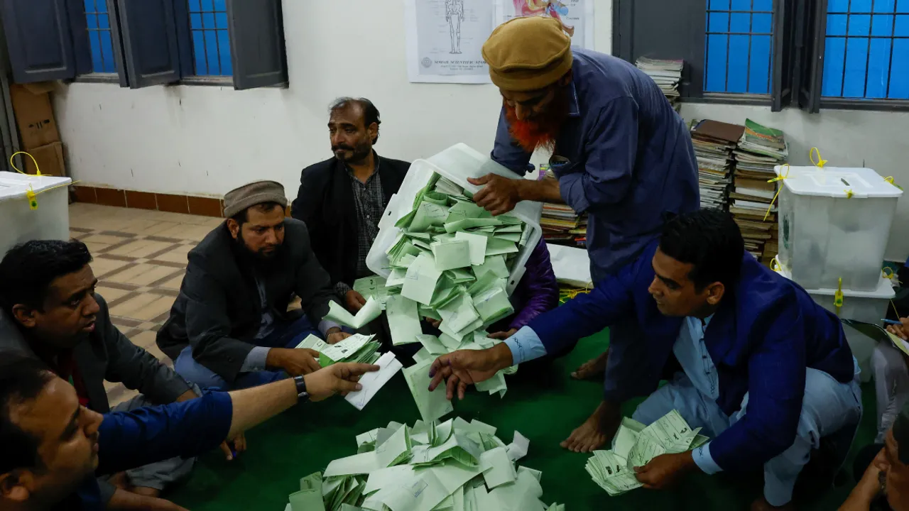  Polling officers count ballot papers during the general election in Karachi, Pakistan. Photograph:(Reuters) 