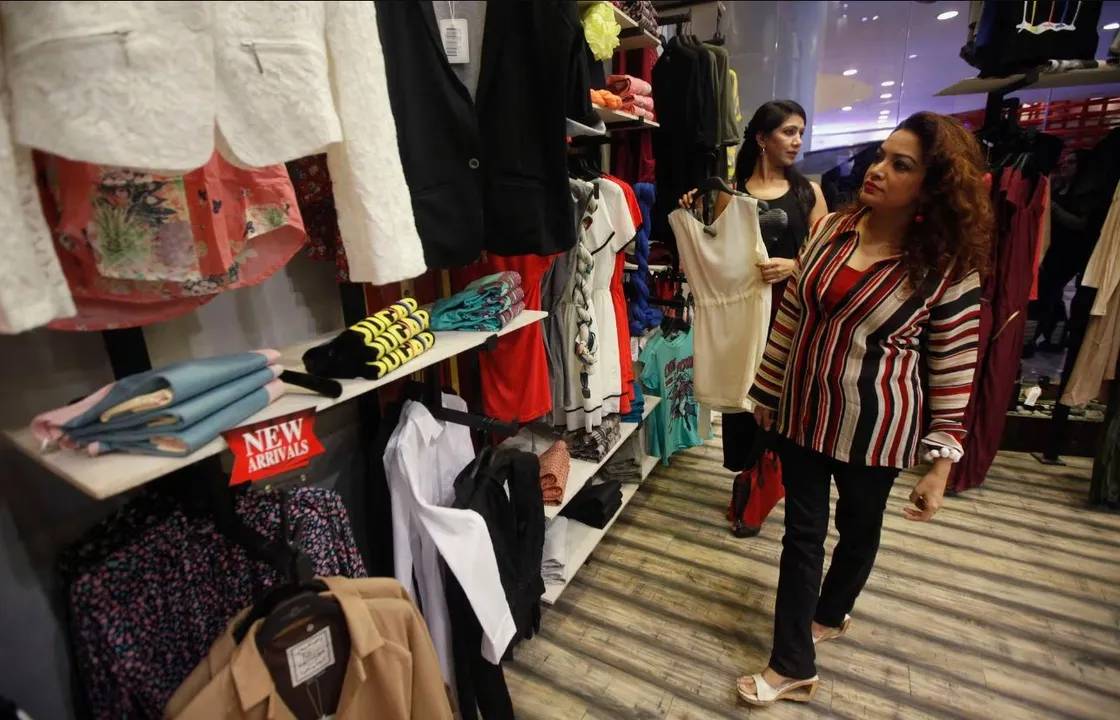  A woman looks at clothes while visiting a shopping mall Photograph:(Reuters) 
