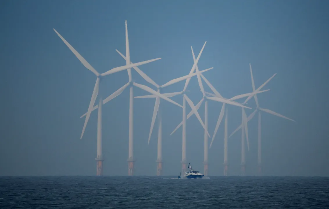  A survey vessel sails past wind turbines at the Burbo Bank offshore wind farm near New Brighton, Britain Photograph:(Reuters) 