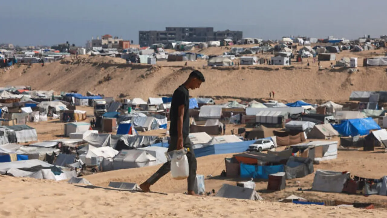  A Palestinian man ferries water at a makeshift camp for displaced people in Rafah in the southern Gaza Strip on April 4, 2024  Photograph:(AFP) 