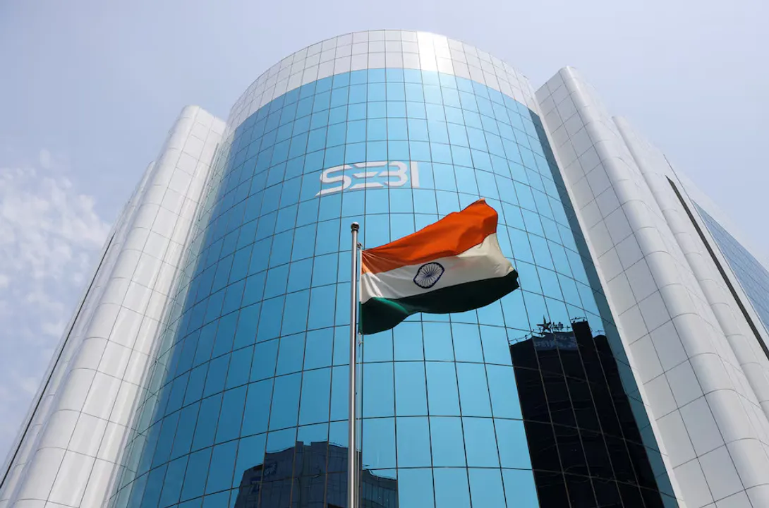  The Indian flag flies in front of the new logo of the Securities and Exchange Board of India (SEBI) at its headquarters in Mumbai, India Photograph:(Reuters) 