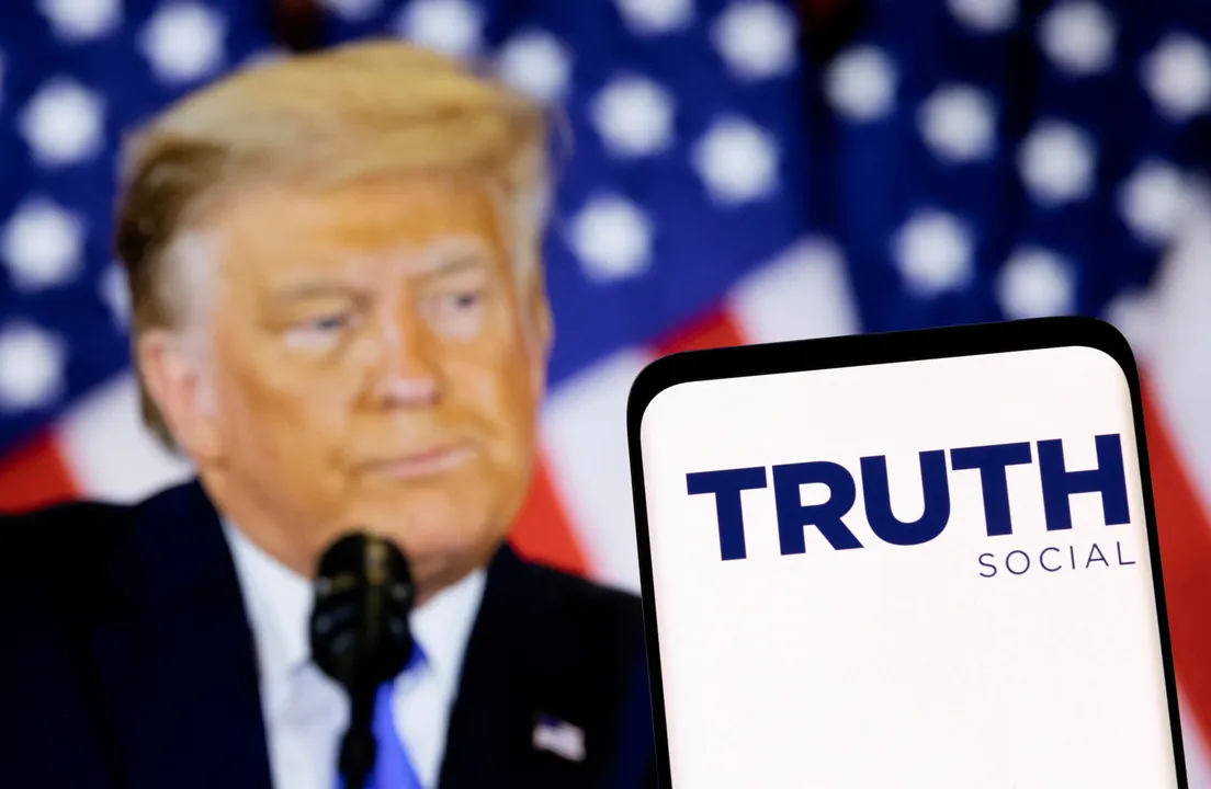  Truth Social logo on the smartphone, Trump in the background illustration. Photograph:(Reuters) 