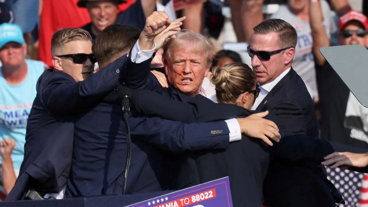 Dramatic images from the incident show Trump with blood streaking across his face as he pumped his fist in the air, appearing to mouth the words "Fight! Fight! Fight!" Photograph:(Reuters) 