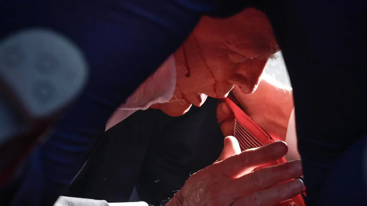  Donald Trump ducked under the podium with blood smearing down his face Photograph:(X) 