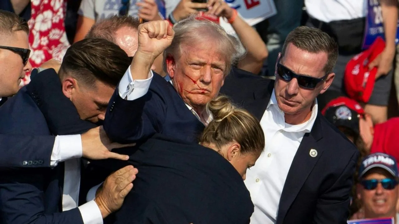  The US Secret Service agents ferry former US president Donald Trump after the shooting Photograph:(AFP) 