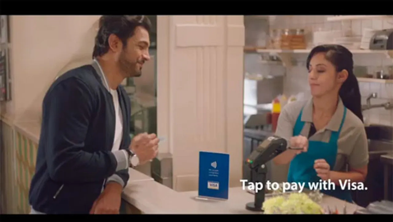 'Tap to pay with Visa. Just like that.' shows the shift from dipping to tapping of the card