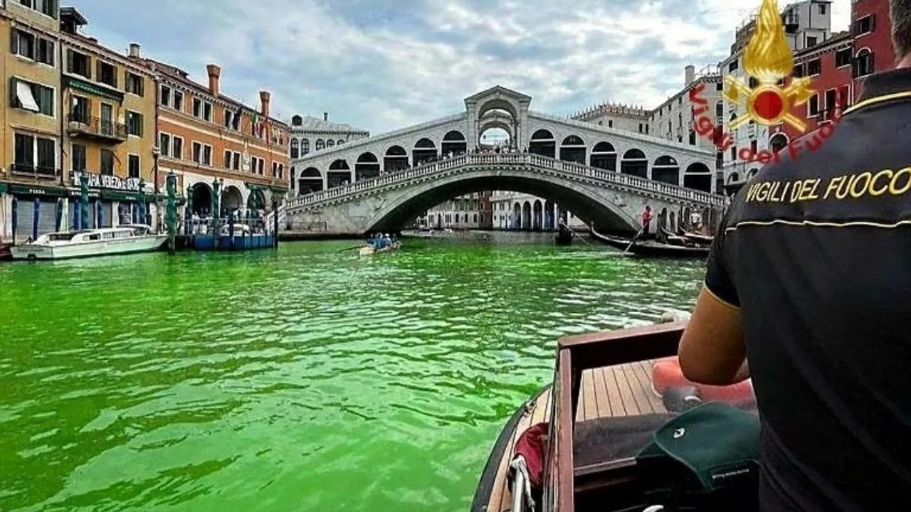 Venice's waters turn green due to an unknown substance near the Rialto Bridge, in Venice, Italy in this handout image released May 28, 2023.
<br>
Image Credit: Vigili del Fuoco/Handout via REUTERS