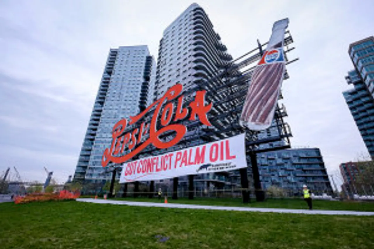 Protesters Scale Iconic Six Story NYC Pepsi Landmark; Drop 100’ Banner Demanding Snack Food Giant Cut Conflict Palm Oil