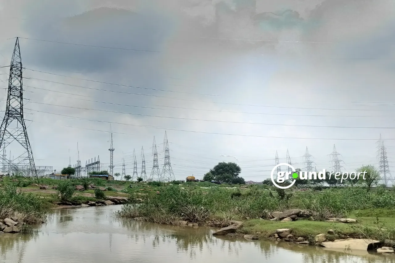 Power lines stretch across a waterlogged field in Madhya Pradesh