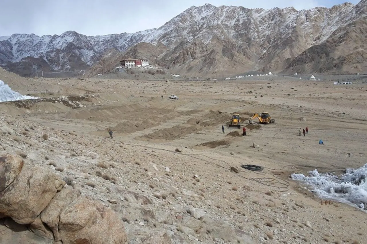 Volunteers and machines are preparing trenches in the Phyang desert for the Ice Stupa and a baby stupa