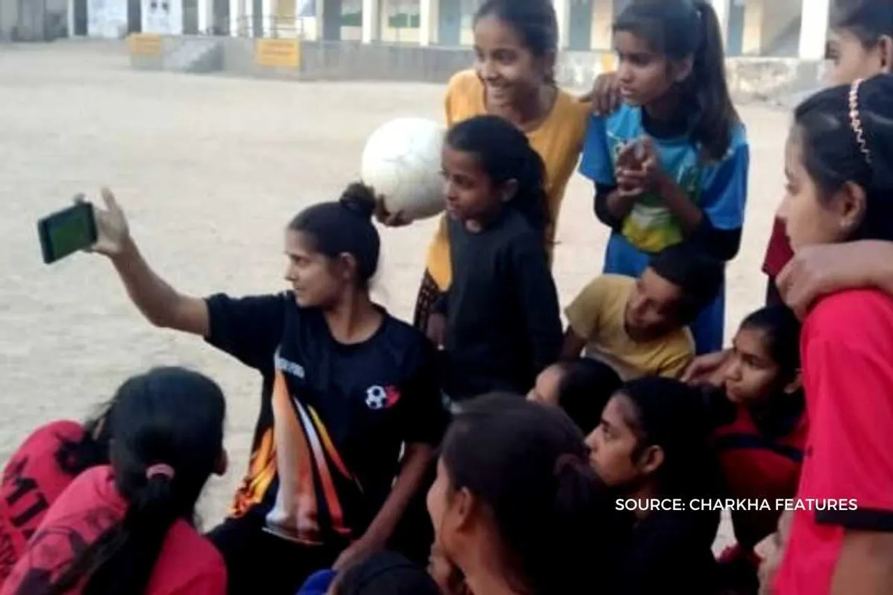 Girls learning soccer skills through smartphones