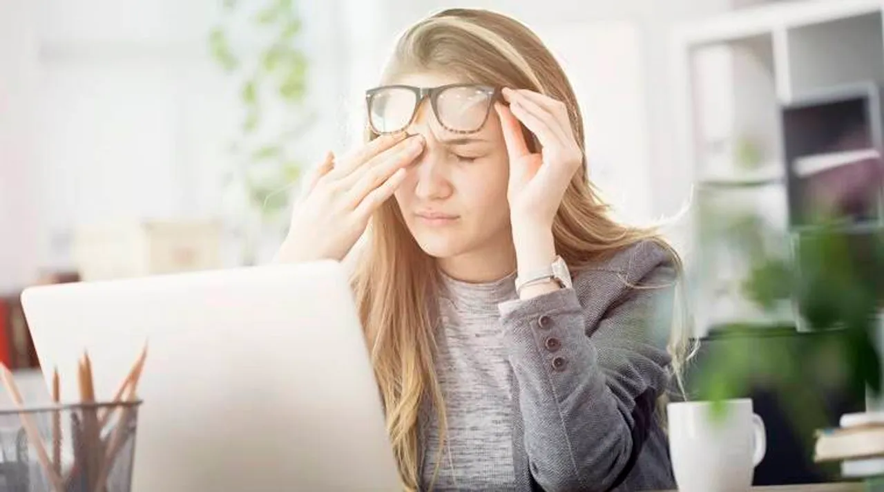 Young tired working woman at work