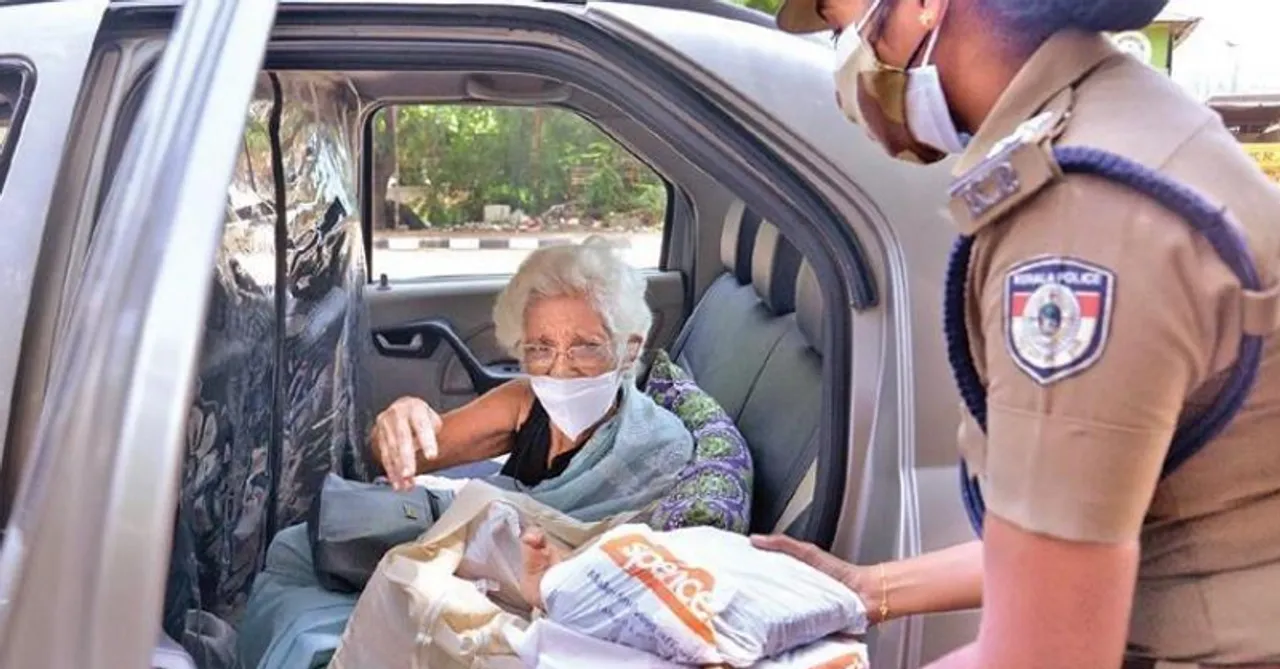 An elderly woman from Kerala donates food packets to police personnel on COVID-19 duty