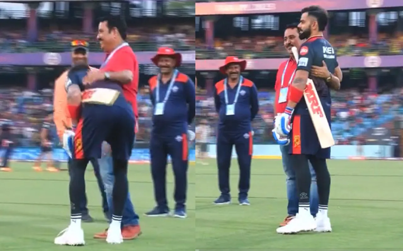 Virat Kohli touching his childhood coach's feet (Source - Twitter)