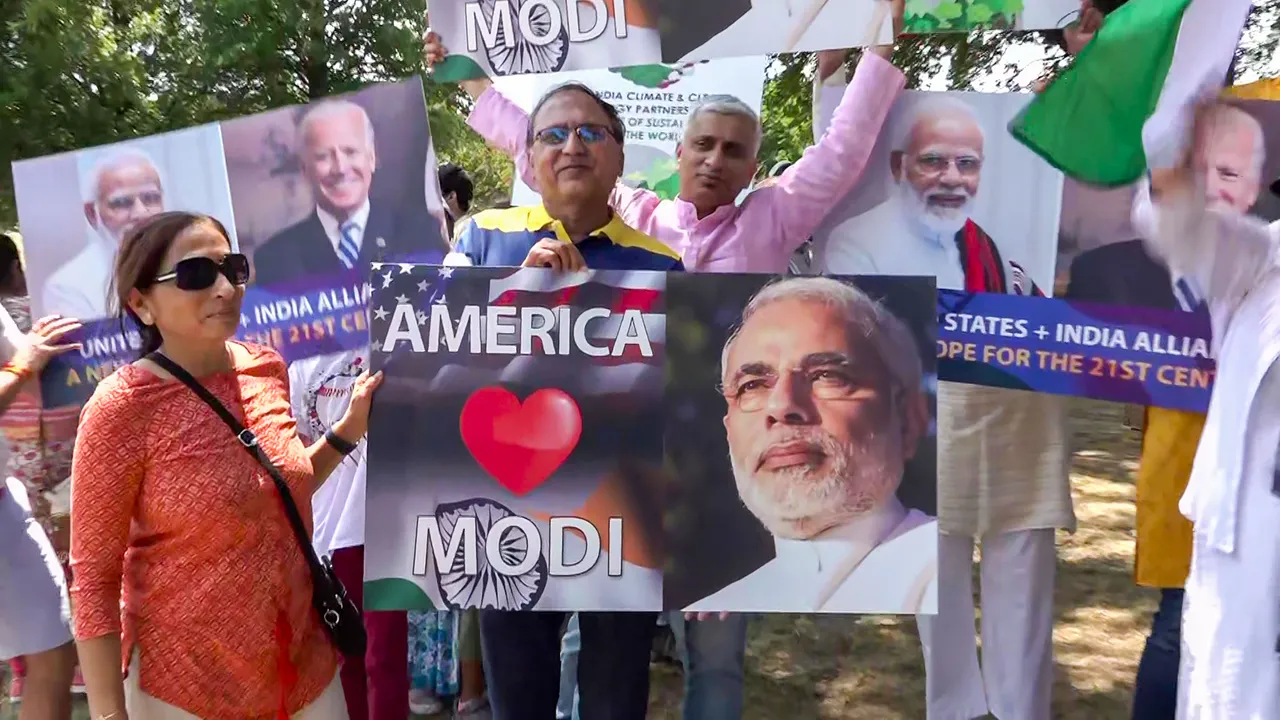 Indian community members hold posters of Prime Minister Narendra Modi during Unity rally, ahead of his visit to the US, in Washington
