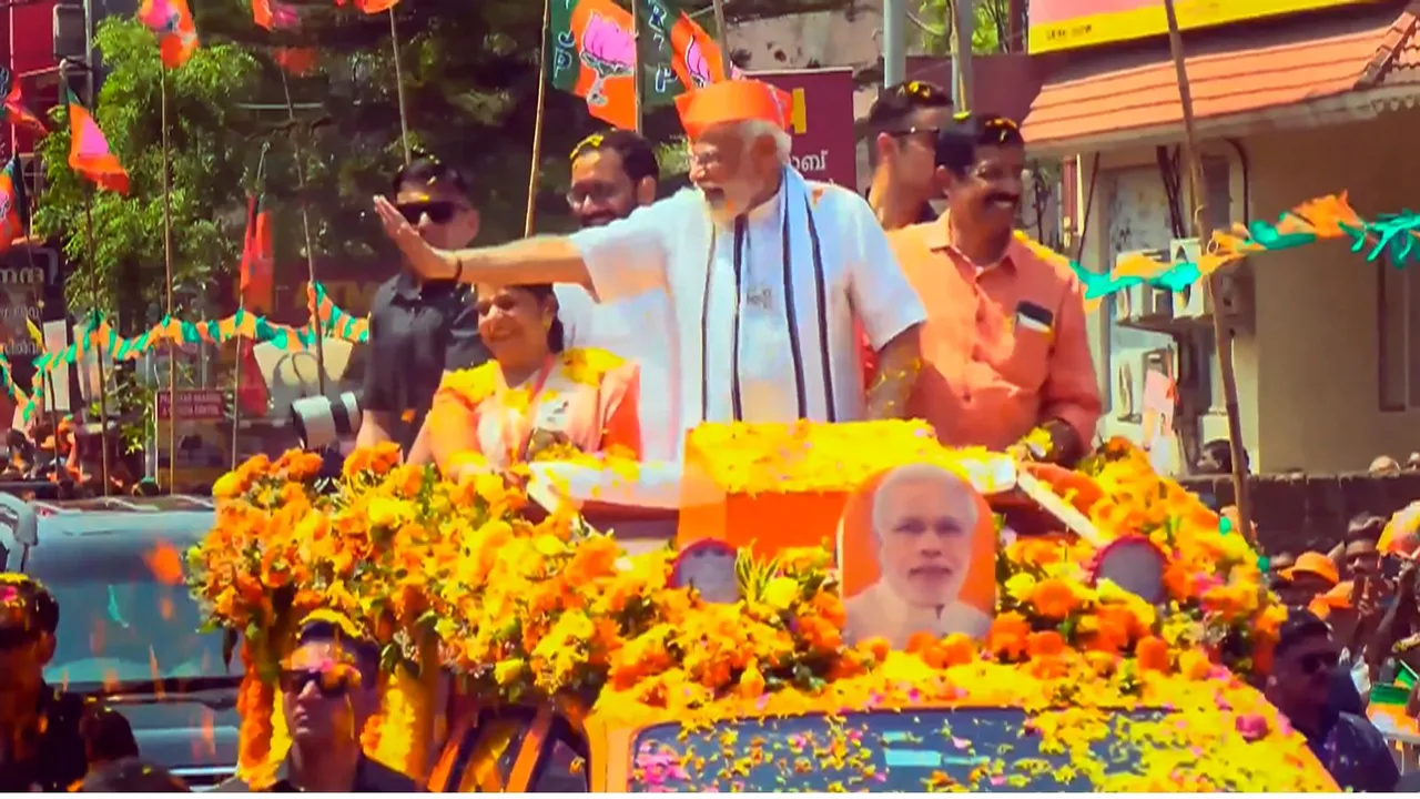 Braving the rising temperatures, people shower flowers on PM Modi in Palakkad