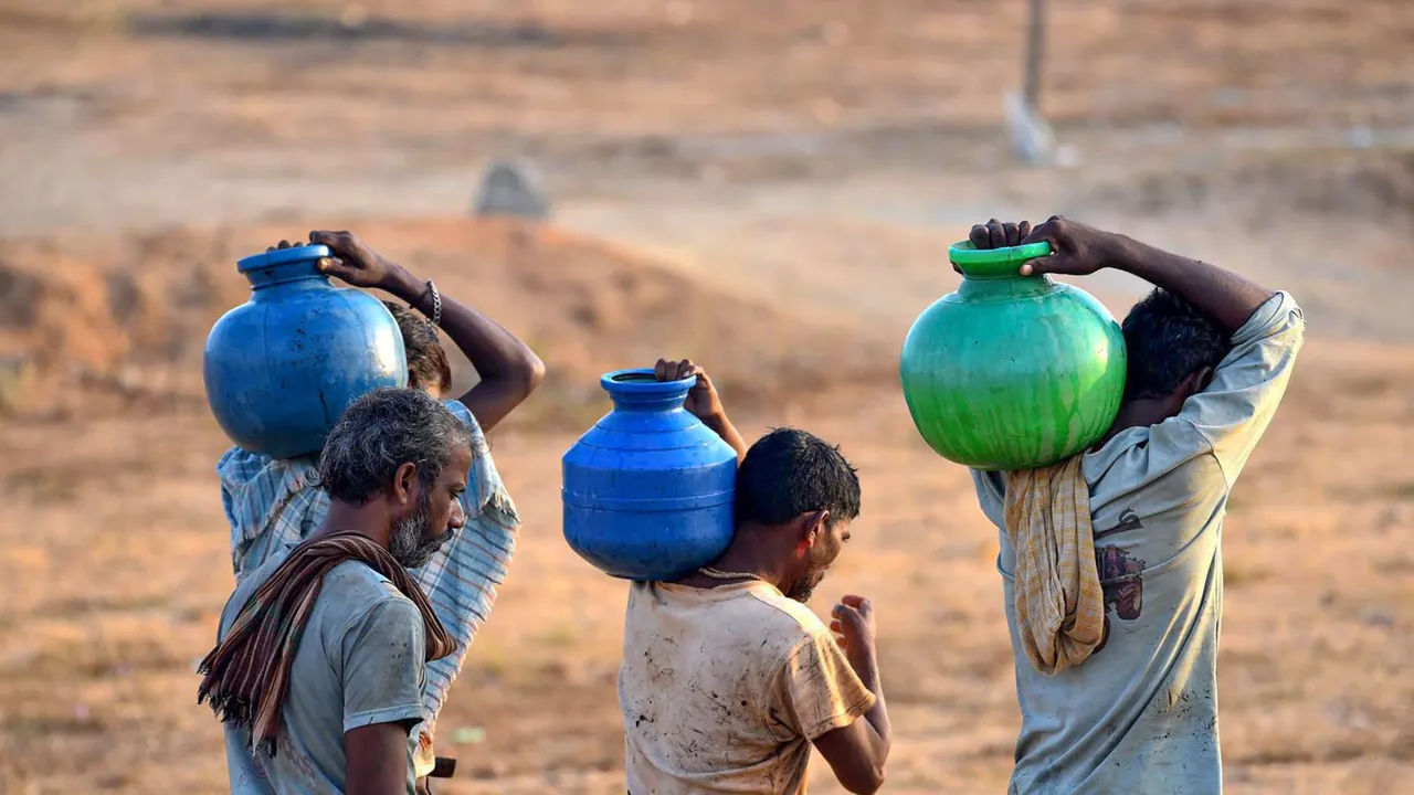 Residents carry pots after collecting drinking water amidst ongoing water crisis, in Chikkamagaluru, Friday, April 5, 2024