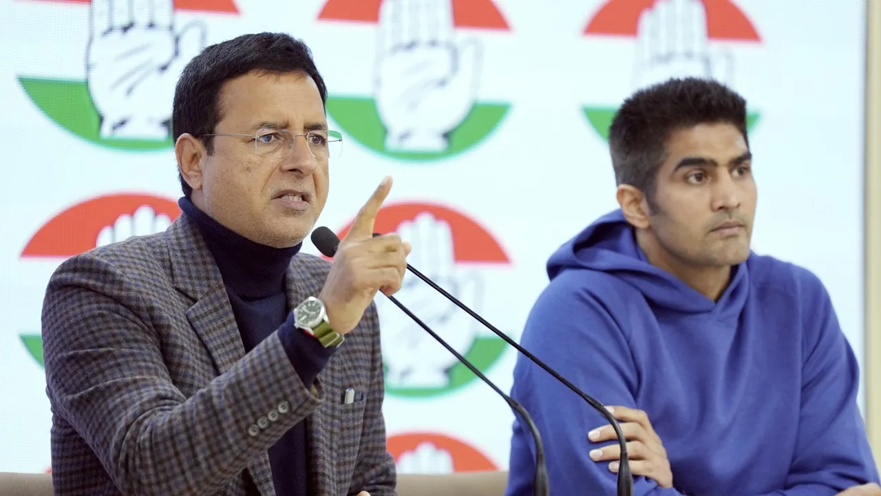Congress leader Randeep Surjewala with party leader and boxer Vijender Singh addresses a press conference at AICC headquarters