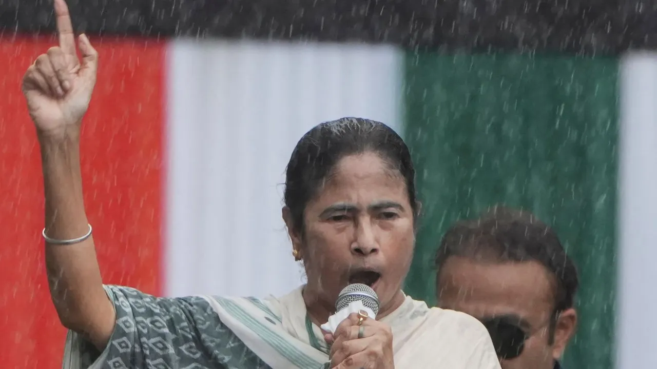 West Bengal Chief Minister Mamata Banerjee addresses the gathering during TMC Martyr's Day rally amid rain, in Kolkata, Sunday, July 21, 2024.