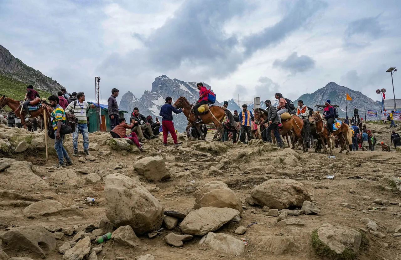 Ponies carry pilgrims at the Pissu Top during Amarnath Yatra 2023, in Amarnath, J & K, Friday.jpg