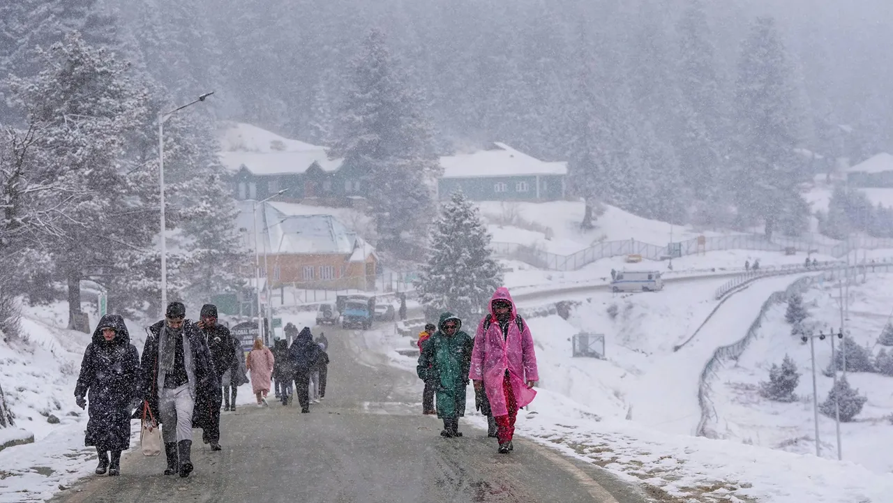 Tourists amid light snowfall at ski resort Gulmarg, in Baramulla