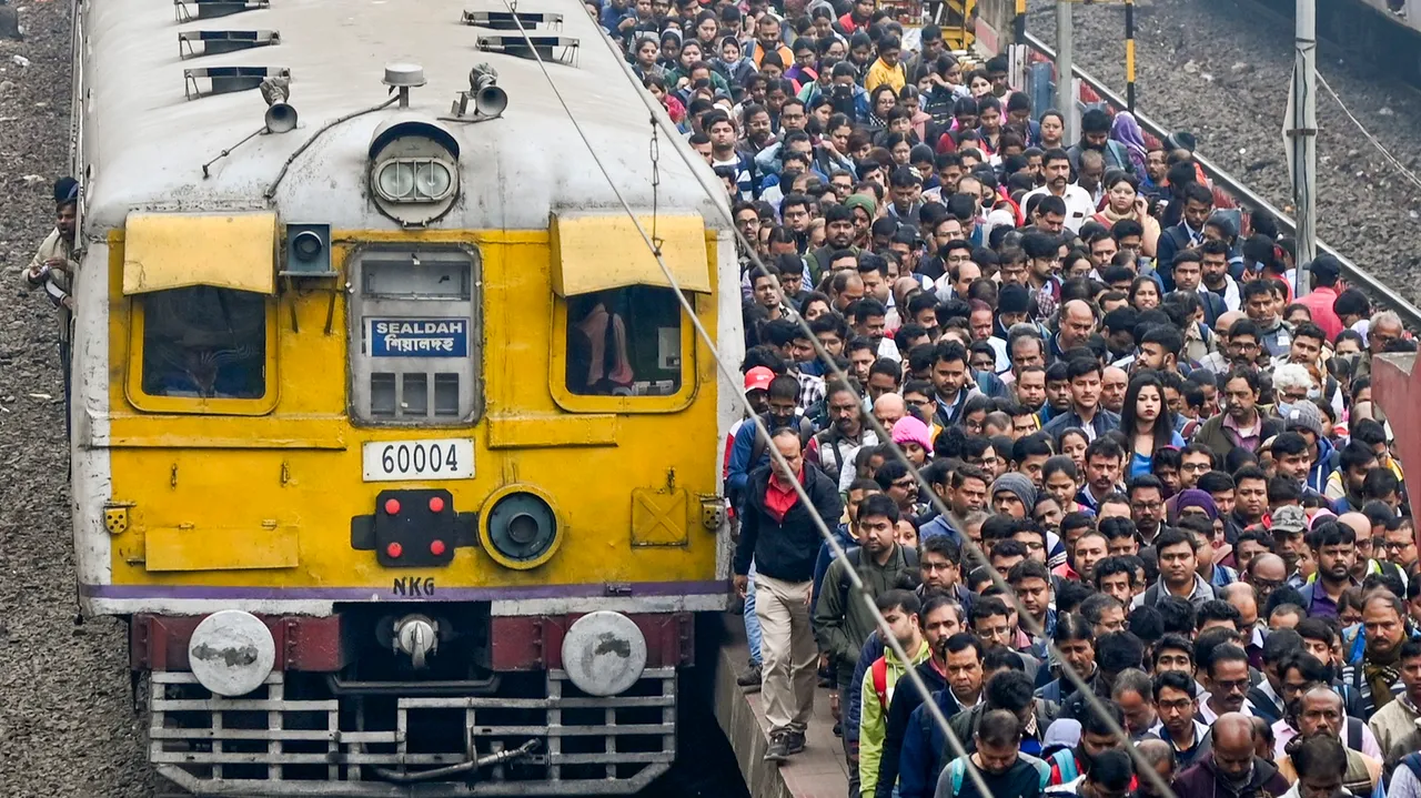 People at a railway platform after deboarding a local train, on the day of the presentation of the Interim Budget 2024 by Union Finance Minister Nirmala Sitharaman, in Kolkata