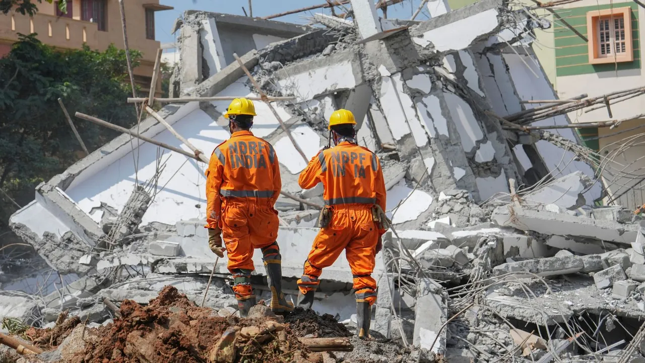 NDRF personnel with a sniffer dog during a rescue operation after an under-construction building collapsed, in Bengaluru, Wednesday, Oct 23, 2024.