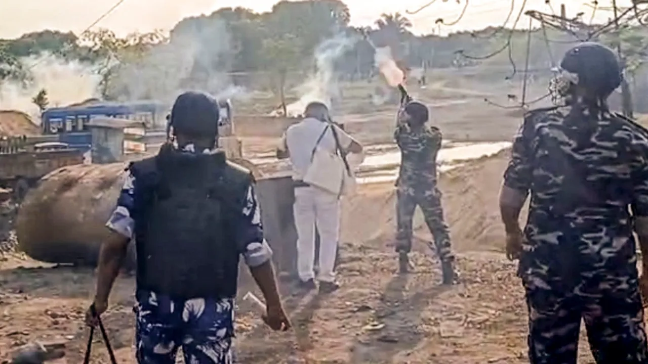 Security personnel use tear gas to disperse demonstrators during a protest against Waqf (Amendment) Act in Murshidabad district on Friday, April 11, 2025.