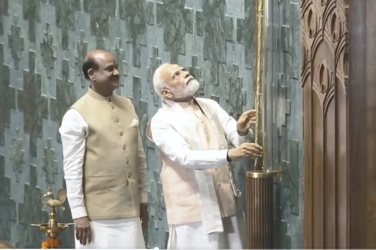 Prime Minister Narendra Modi installs the 'Sengol' in an enclosure on the right side of the Speaker's chair in the Lok Sabha chamber at the inauguration of the new Parliament building