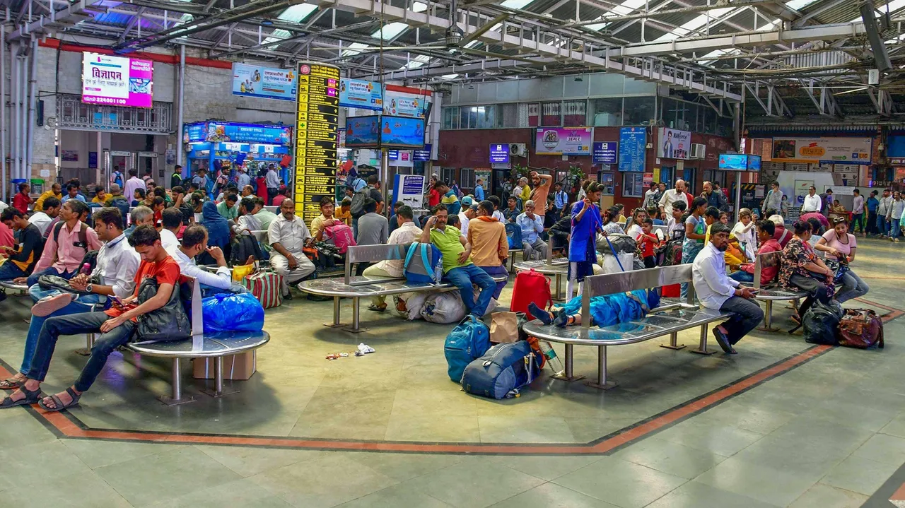 Commuters wait at the Chhatrapati Shivaji Maharaj Terminus (CSMT)