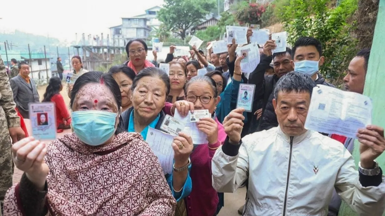 People show their ID cards as they wait to cast their votes for Lok Sabha elections, in Namchi district, Sikkim, Friday, April 19, 2024. 