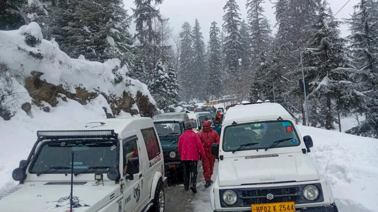 Vehicles stuck in a traffic jam after a fresh snowfall, in Solang valley of Manali, Saturday, Feb. 3, 2024.