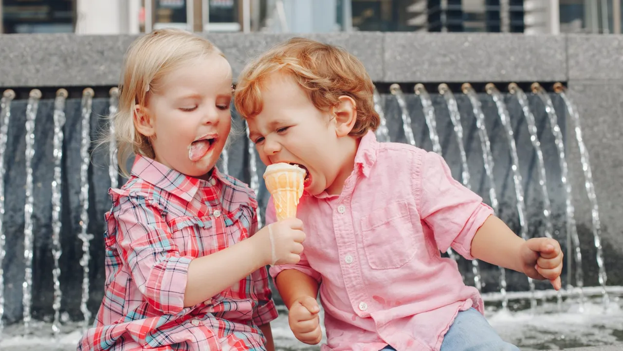 Girl sharing ice cream with a boy