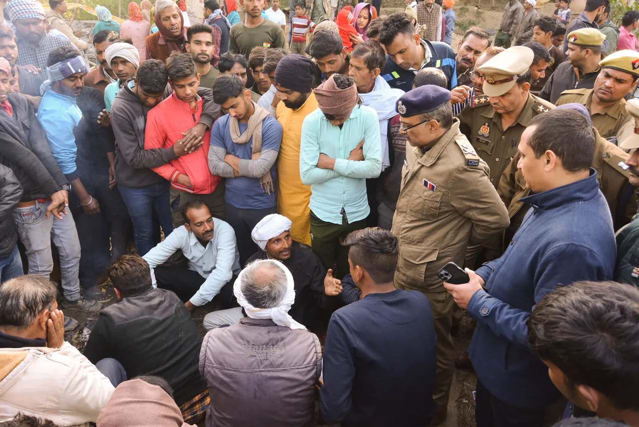 Relatives and family members of the mother-daughter duo who allegedly died after they immolated themselves during an anti-encroachment drive on Monday, sit on 'dharna', in Kanpur Dehat district