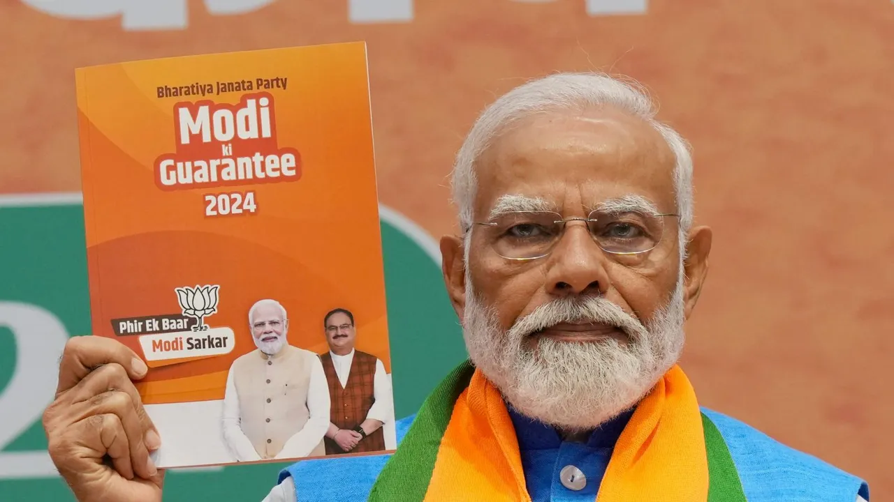 Prime Minister Narendra Modi during the release of the party's election manifesto Sankalp Patra at the party headquarters, in New Delhi, Sunday, April 14, 2024
