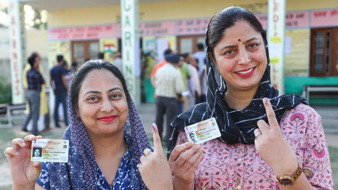 Voters show their ink-marked fingers and ID cards after casting their votes for the 2nd phase of Lok Sabha elections, in Jammu, Friday, April 26, 2024