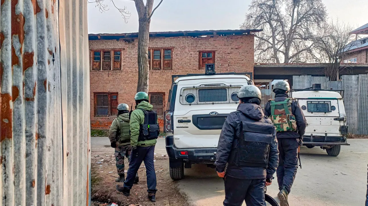Security personnel during a cordon and search operation following an encounter between terrorists and security forces, in Kulgam district