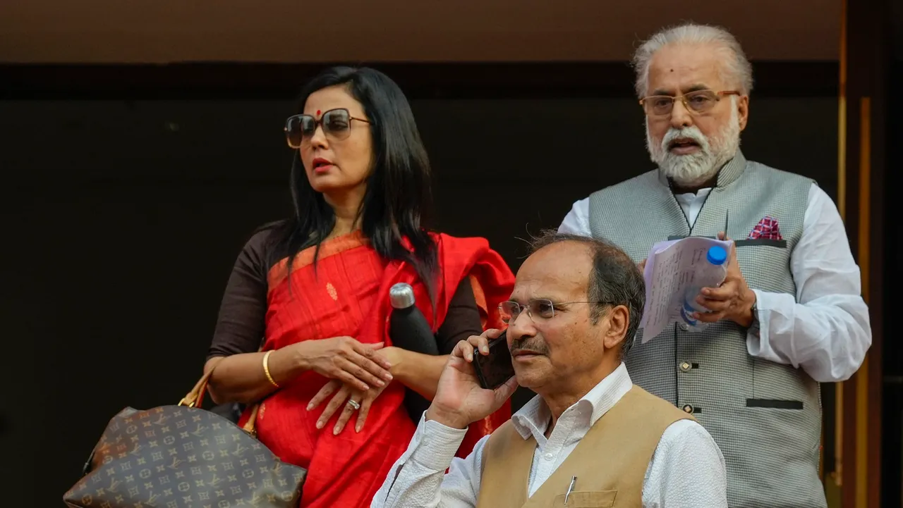 Congress MP Adhir Ranjan Chowdhury and TMC MPs Mahuha Moitra and Sudip Bandyopadhyay on the first day of Winter session of Parliament