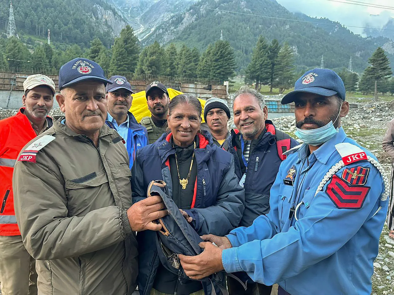 ASI Darshan Kumar and HC Satpal of the J&K Police hand over a bag containing ?80000, a mobile phone, and Yatra documents to its owner, an Amarnath Yatra 2023 pilgrim, after tracing her