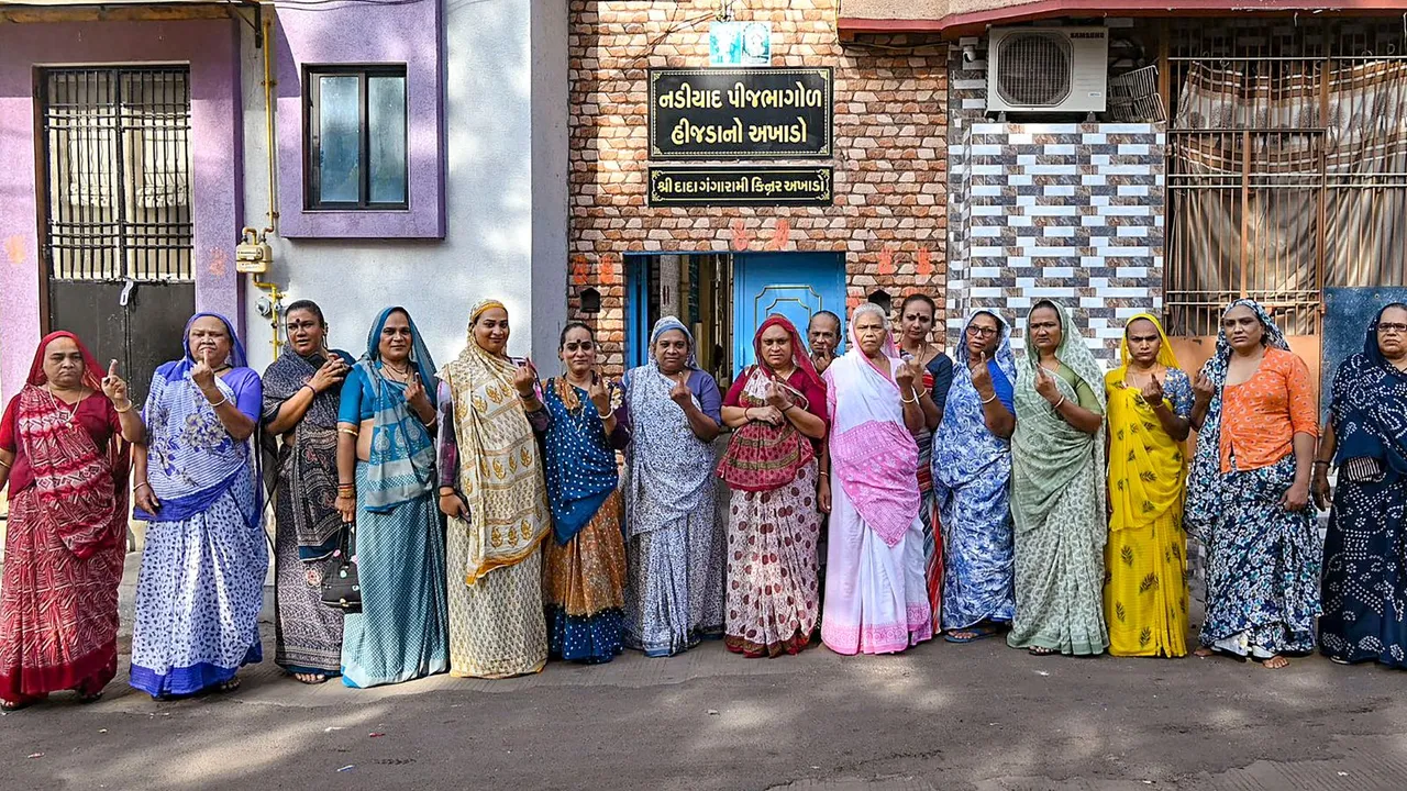 Transgenders show their inked fingers after casting their votes at a polling station during the 3rd phase of Lok Sabha polls, in Kheda, Gujarat, Tuesday, May 7, 2024