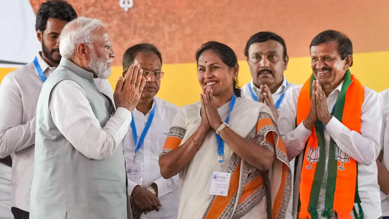 Prime Minister Narendra Modi greets BJP's Bangalore North candidate Shobha Karandlaje