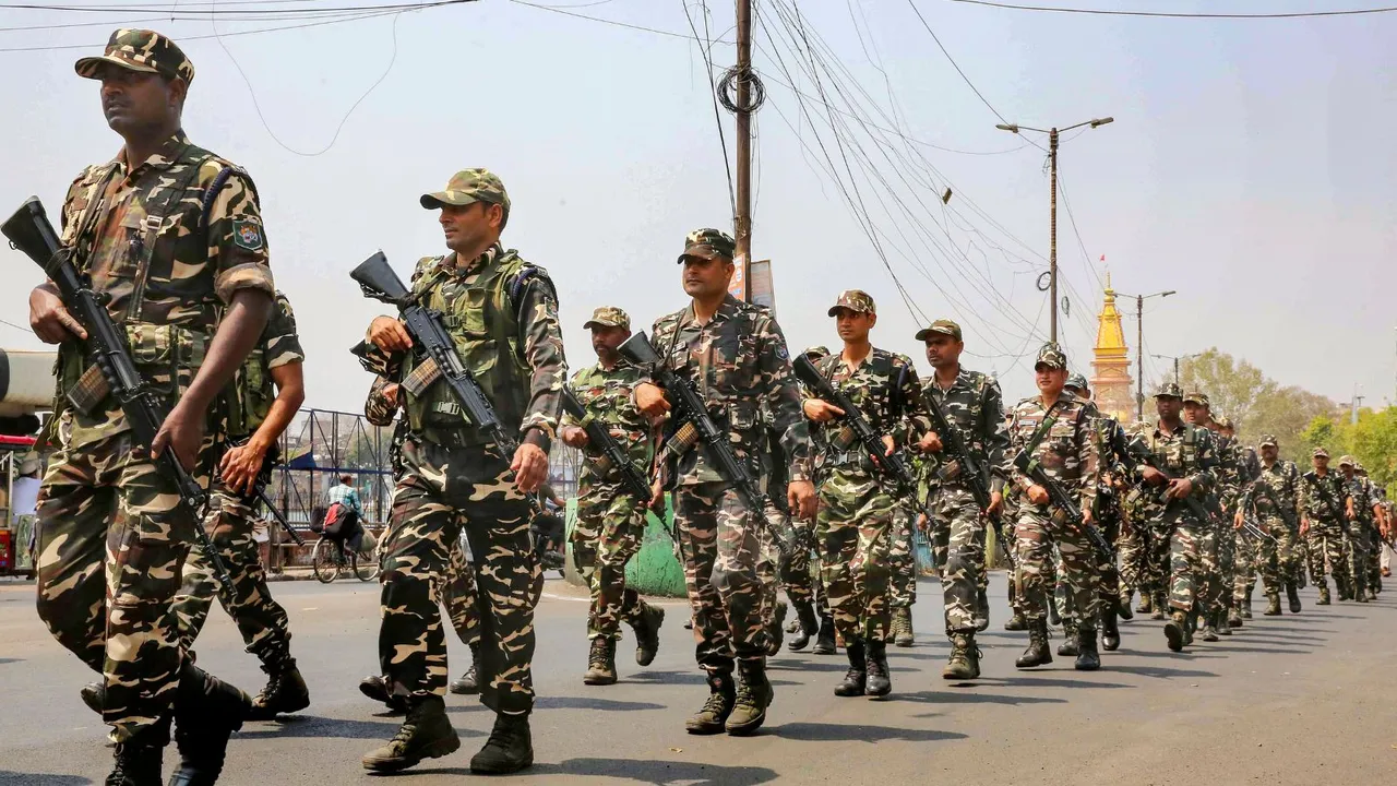 Police personnel conduct a flag march after the Model Code of Conduct was enforced following the announcement of the schedule of Lok Sabha elections, in Bhopal