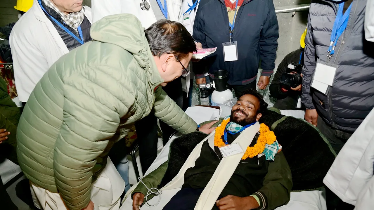 Uttarakhand Chief Minister Pushkar Singh Dhami greets a rescued worker after a successful evacuation at the under-construction Silkyara Bend-Barkot Tunnel