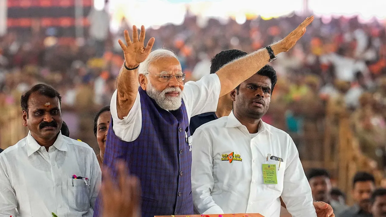 Prime Minister Narendra Modi waves at supporters as he arrives for a public meeting ahead of Lok Sabha elections, in Salem, Tamil Nadu