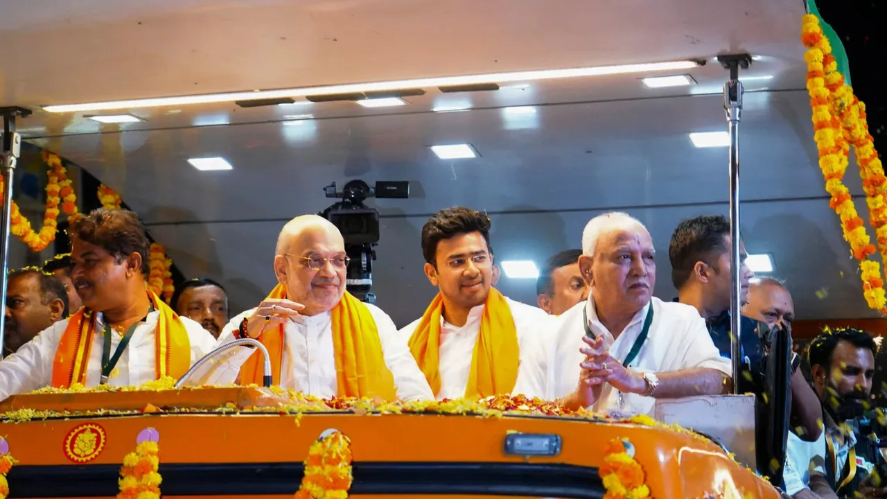 Union Home Minister Amit Shah with BJP's Bengaluru South candidate Tejasvi Surya and former Karnataka CM BS Yediyurappa during a roadshow for Lok Sabha polls, in Bengaluru,Tuesday, April 23, 2024