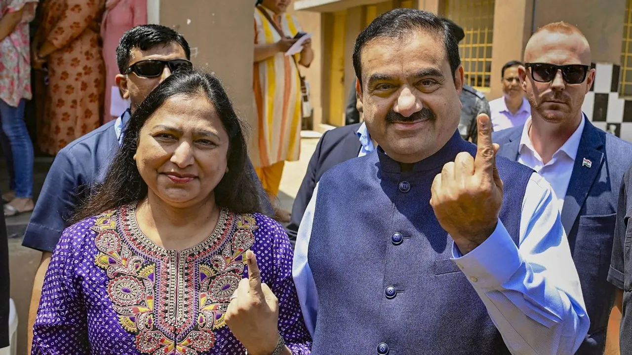 Adani Group Chairman Gautam Adani And His Wife Priti Adani Show Their Inked Fingers After Casting Votes At A Polling Booth, During The 3rd Phase Of Lok Sabha Polls, In Ahmedabad, Tuesday, May 7, 2024